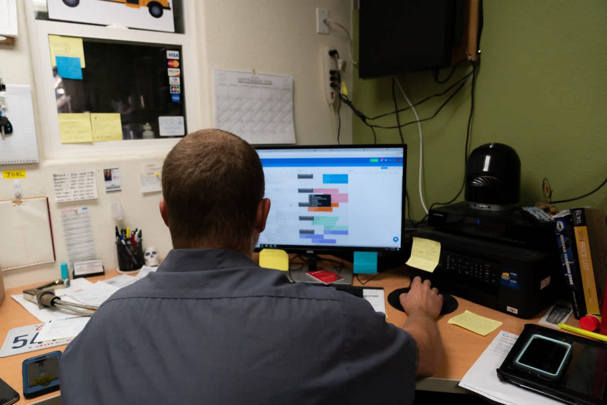 man at computer looking at schedule