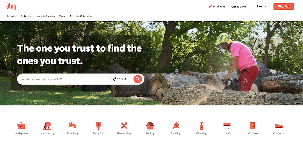 - Housecall Pro Angi homepage hero: worker cutting logs in a sunlit yard; bold headline and a search bar for services