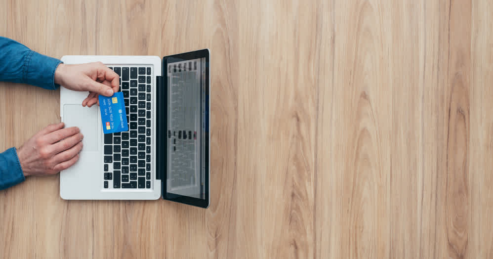 - Housecall Pro credit card used at a laptop viewed from overhead