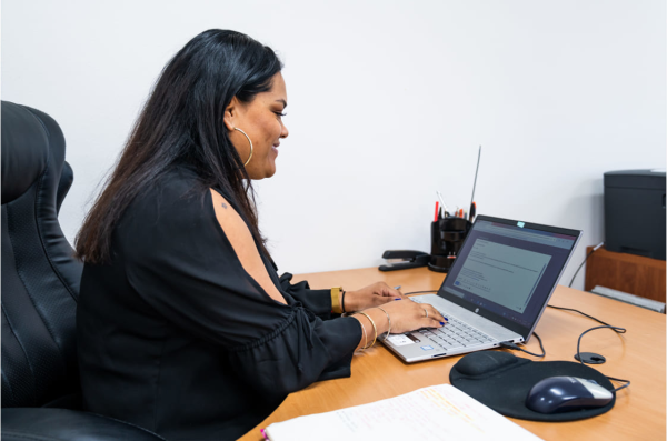 Pro entering accounting info on her laptop