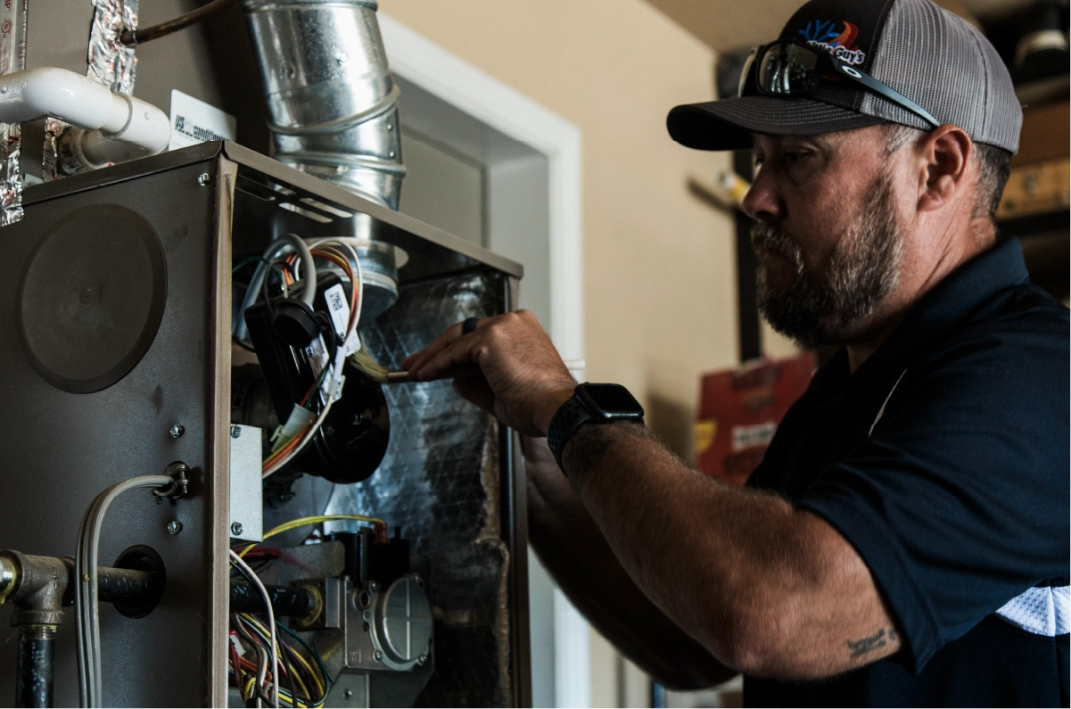 HVAC pro fixing wiring in home heater