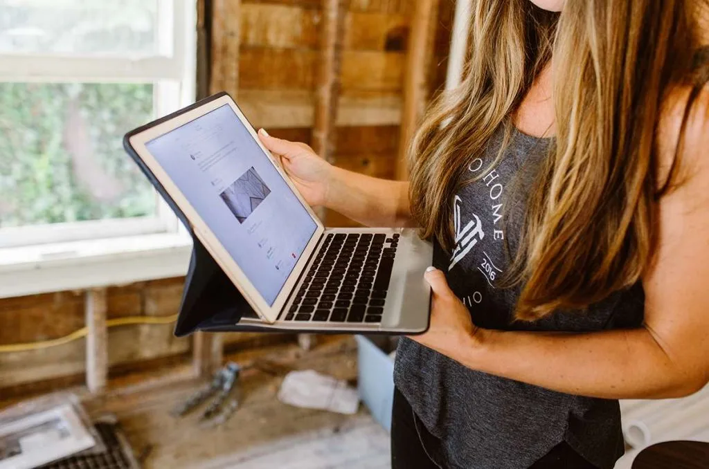 Lady pro using Buildbook home construction management software on laptop