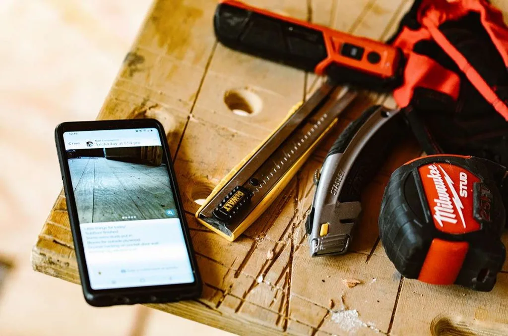 Mobile phone next to hand tools