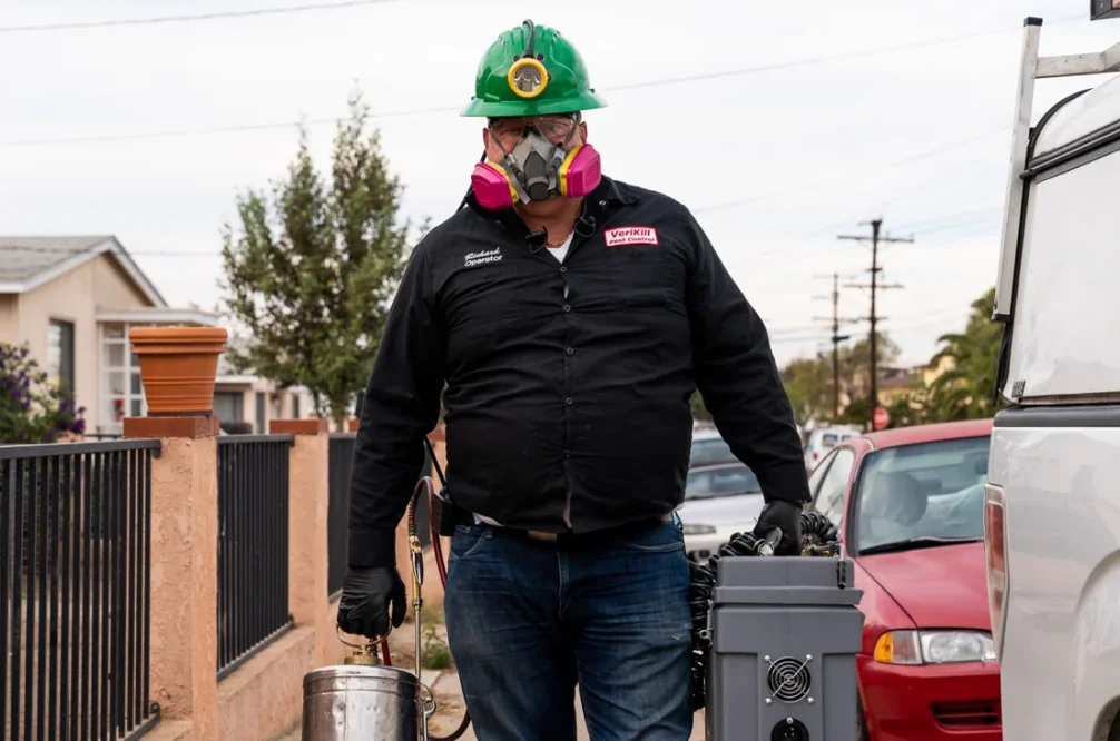Pro with facemask geared up for pest control job