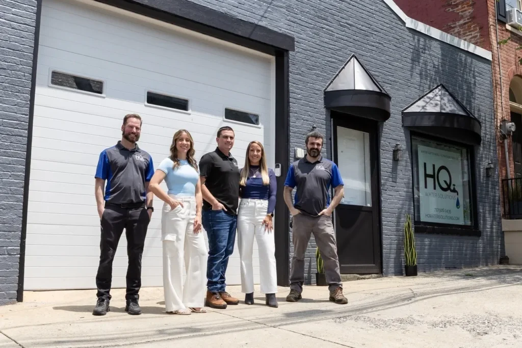 - Housecall Pro Friendly HQ Water Solutions team showcasing professionalism and teamwork outside their headquarters.