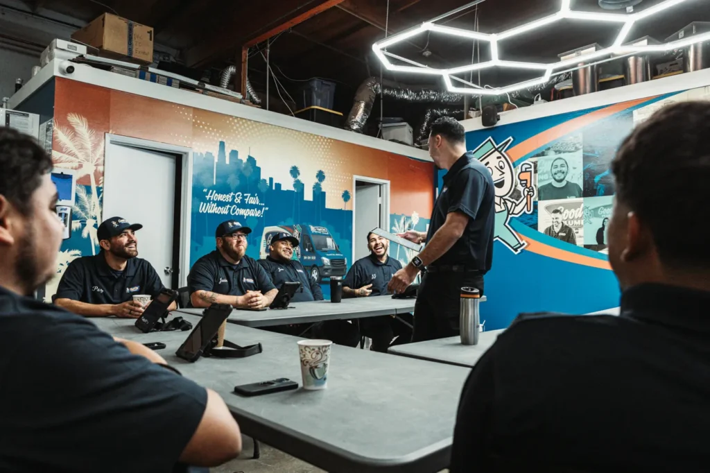 - Housecall Pro Professional plumbing team gathered for a team meeting focused on training and communication.