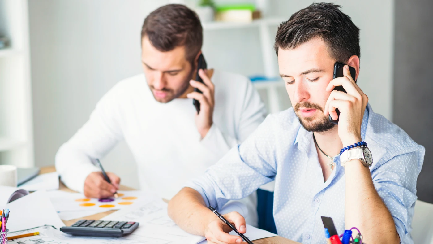 Small business owners reviewing financial documents and handling tax paperwork