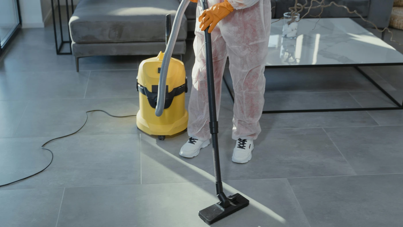 Pro cleaner cleaning a living room using a Vacuum Cleaner