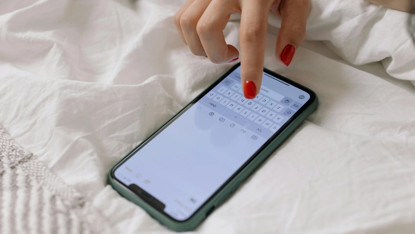 Person typing a text message on a smartphone