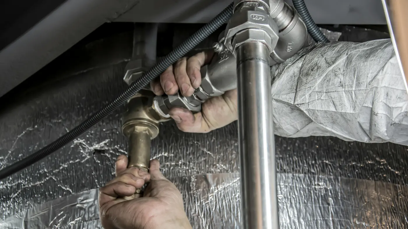 Plumber installing a pipe