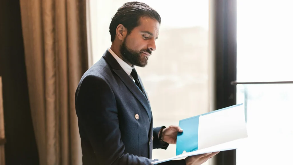 Business professional reviewing documents, representing timesheet templates for service businesses