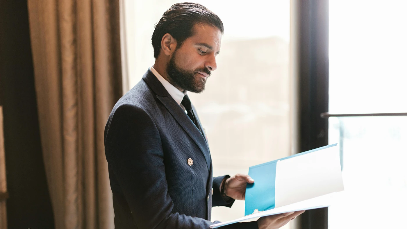 Business professional reviewing documents, representing timesheet templates for service businesses