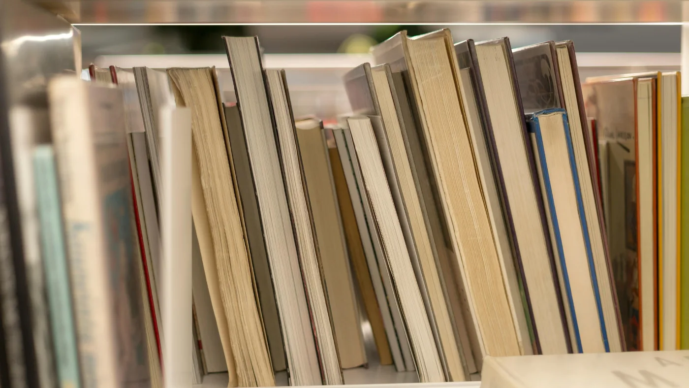 Books on shelf representing top HVAC resources for beginners and professionals