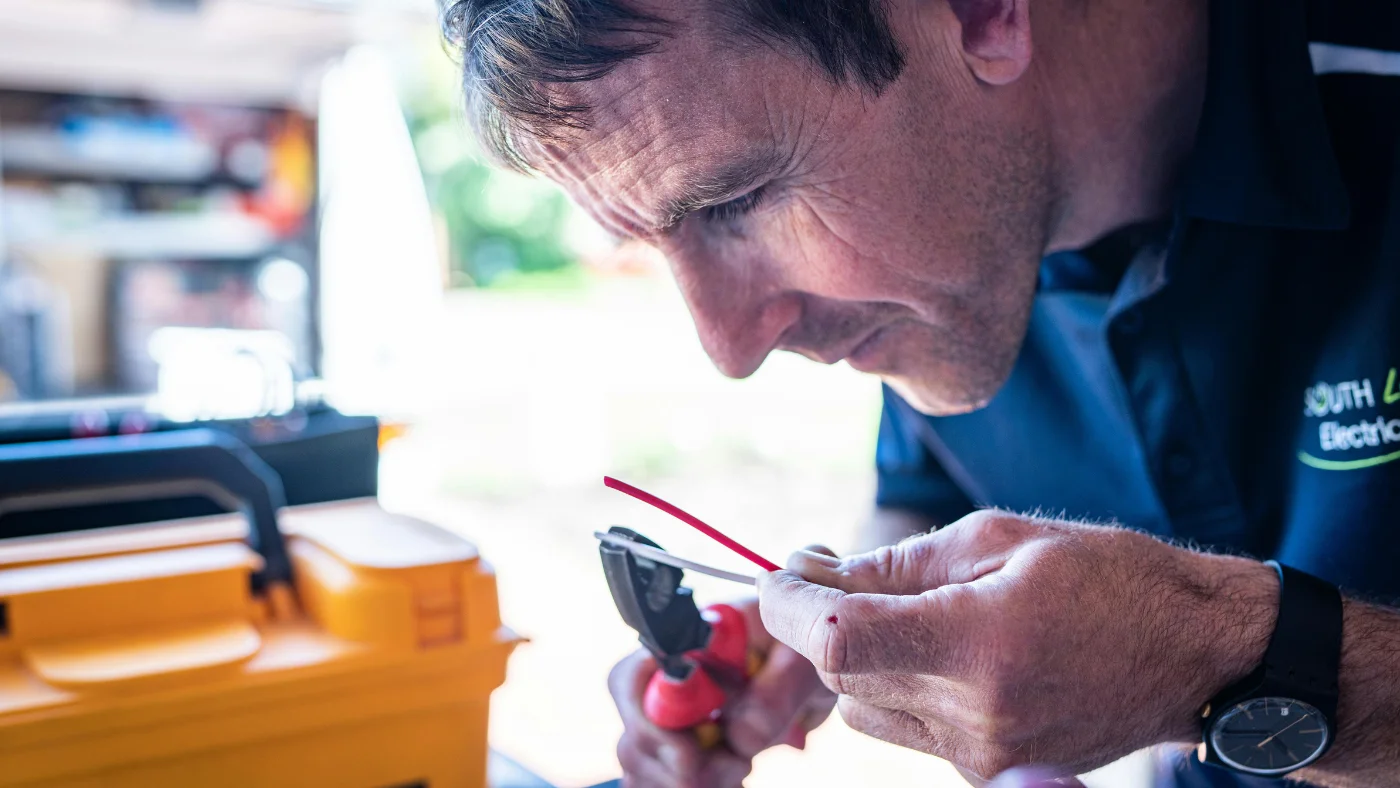 Pro technician working with wiring using a tool