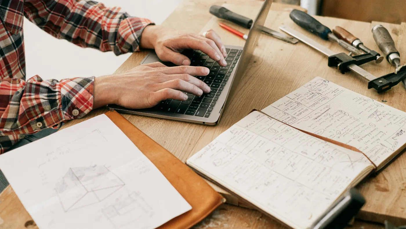 Pro worker using laptop on a wooden table