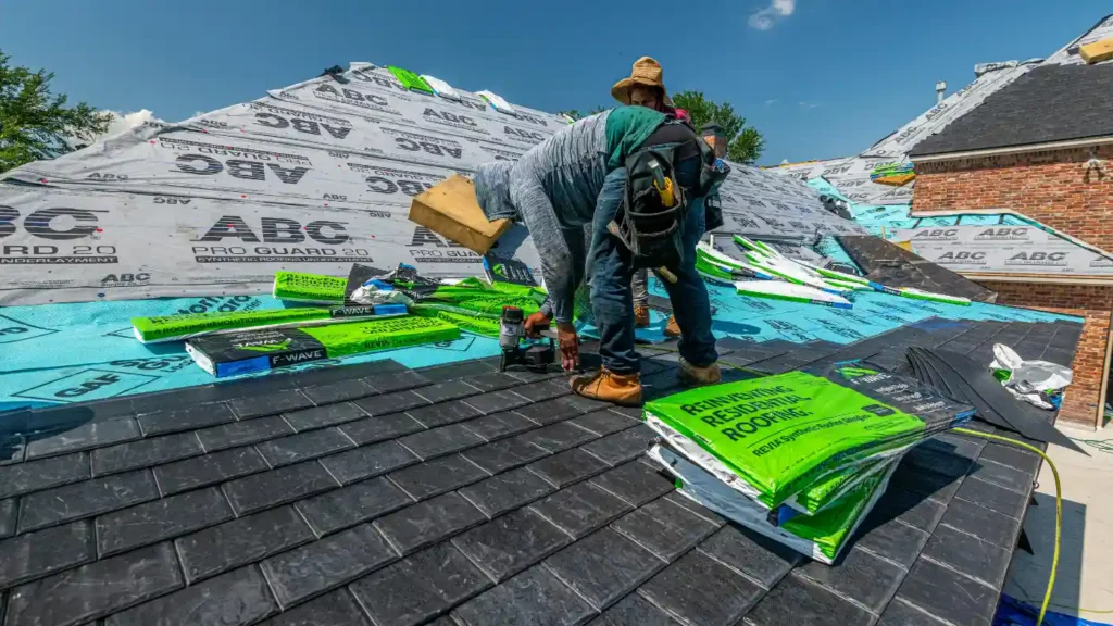 roofers installing shingles on new roof