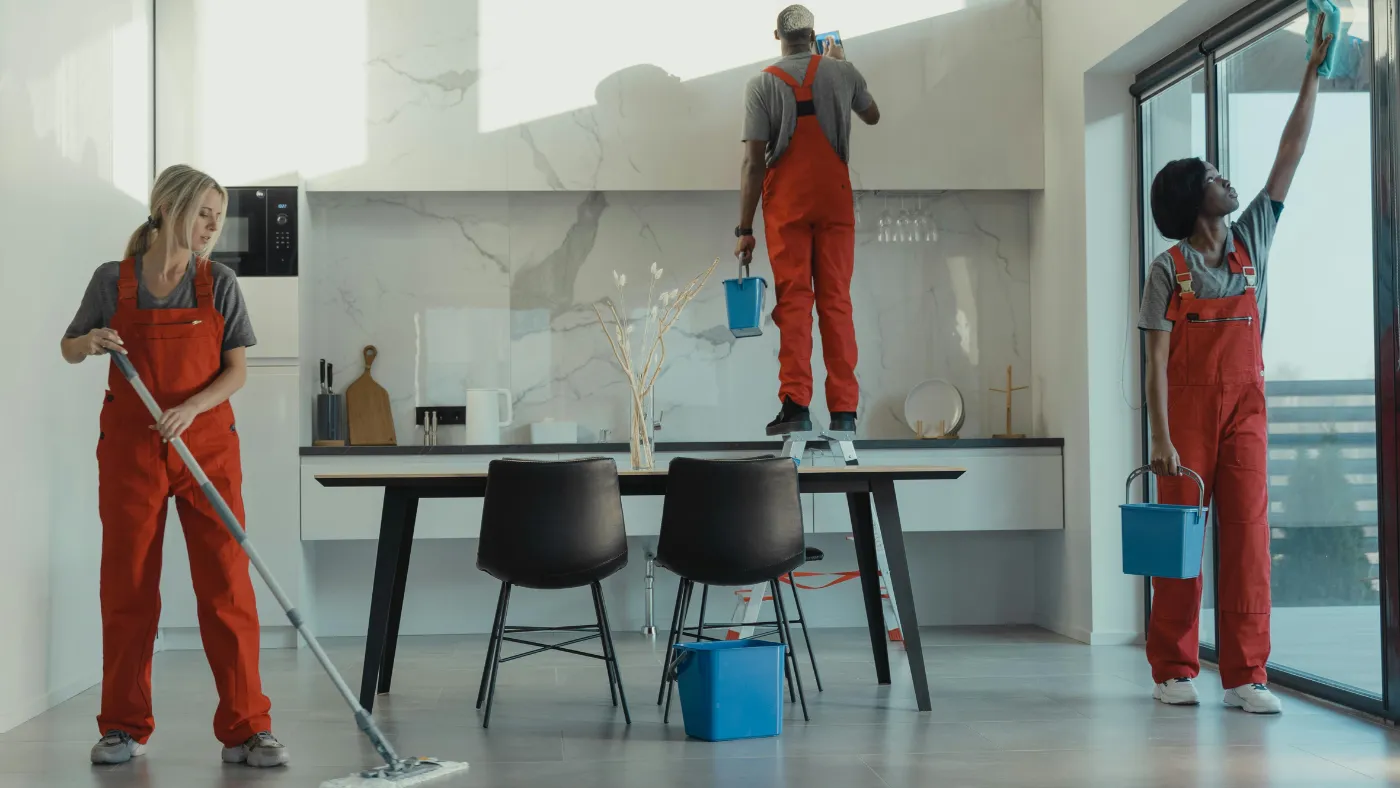 Commercial cleaning team cleaning floors, windows, and surfaces in a modern home
