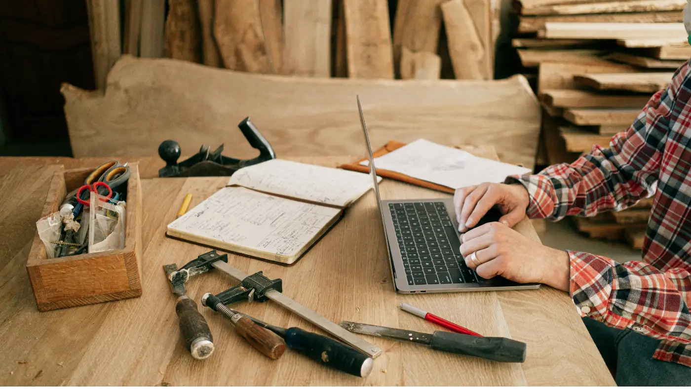 man using laptop on a wooden table