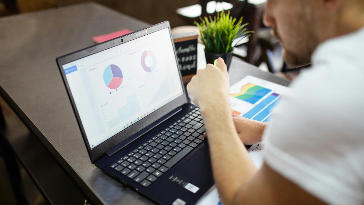 ma using laptop and looking at a dashboard