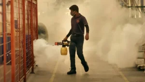 Pest control technician using a fogger for commercial pest treatment
