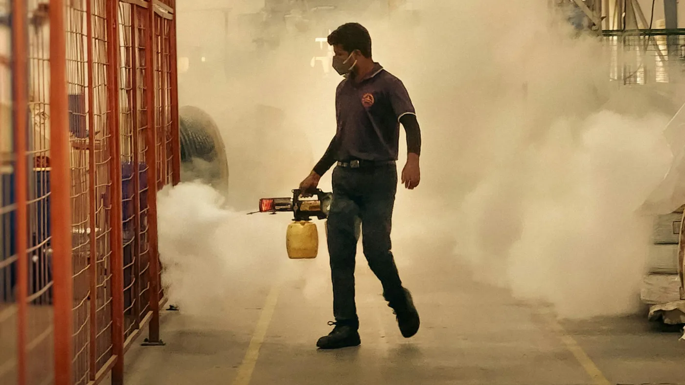 Pest control technician using a fogger for commercial pest treatment