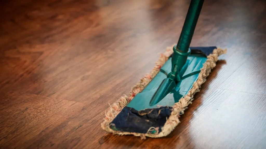 Mop cleaning hardwood floor representing professional cleaning services