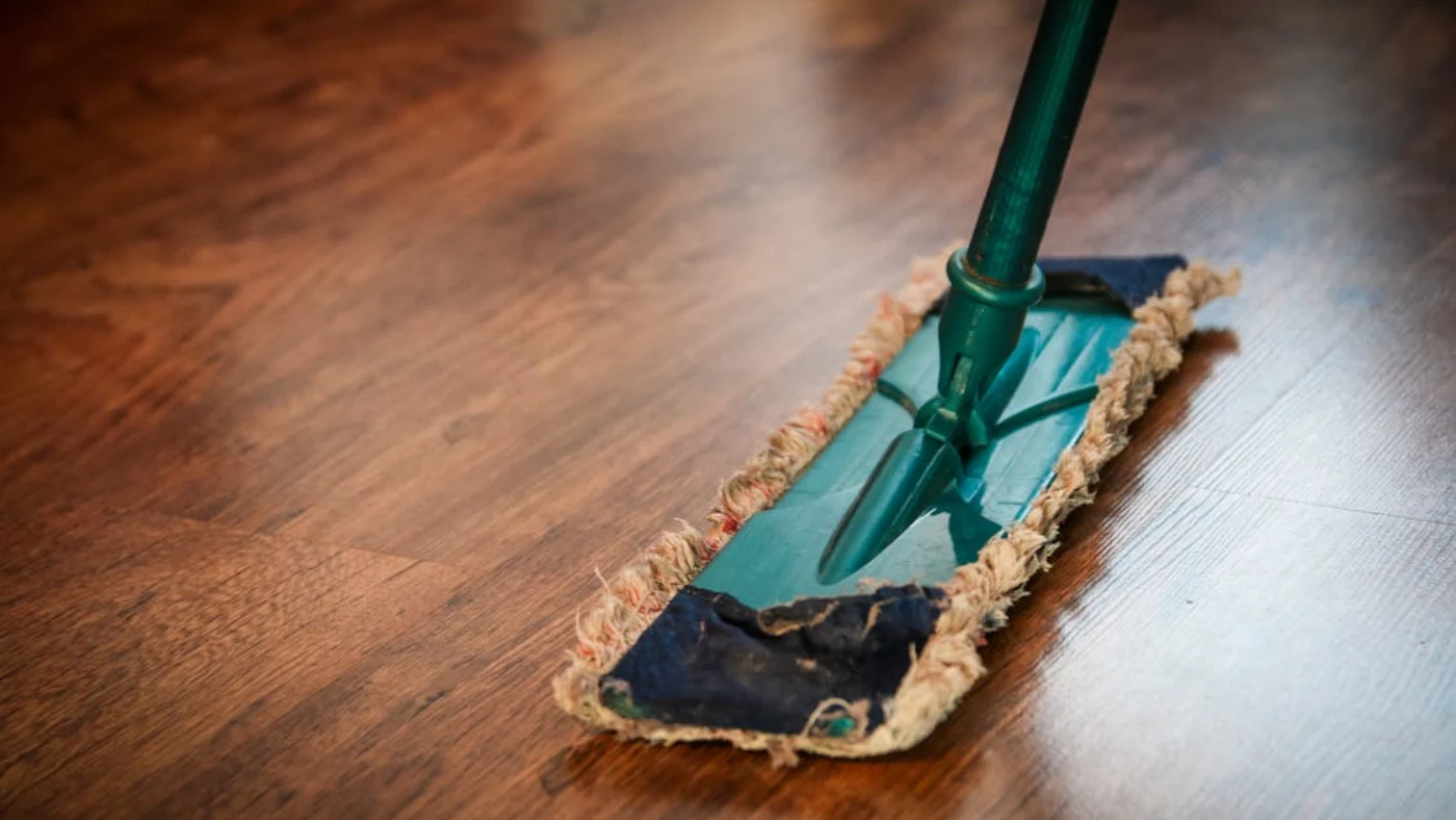 Mop cleaning hardwood floor representing professional cleaning services