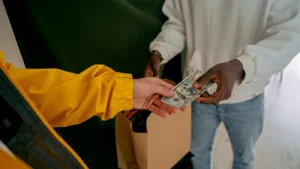 Handyman receiving cash payment from client for home repair service