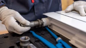 Plumber assembling pipe fitting during plumbing service job