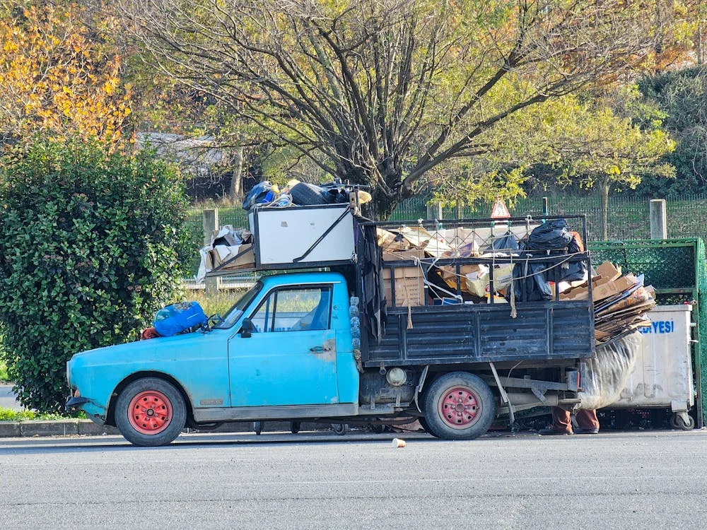 junk removal truck filled with furniture and construction waste