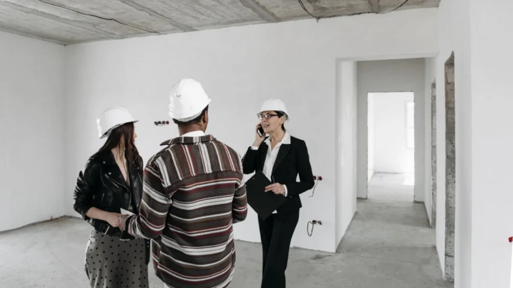 - Housecall Pro Flooring professional explaining installation costs, project scope, and pricing details to customers during a home consultation.