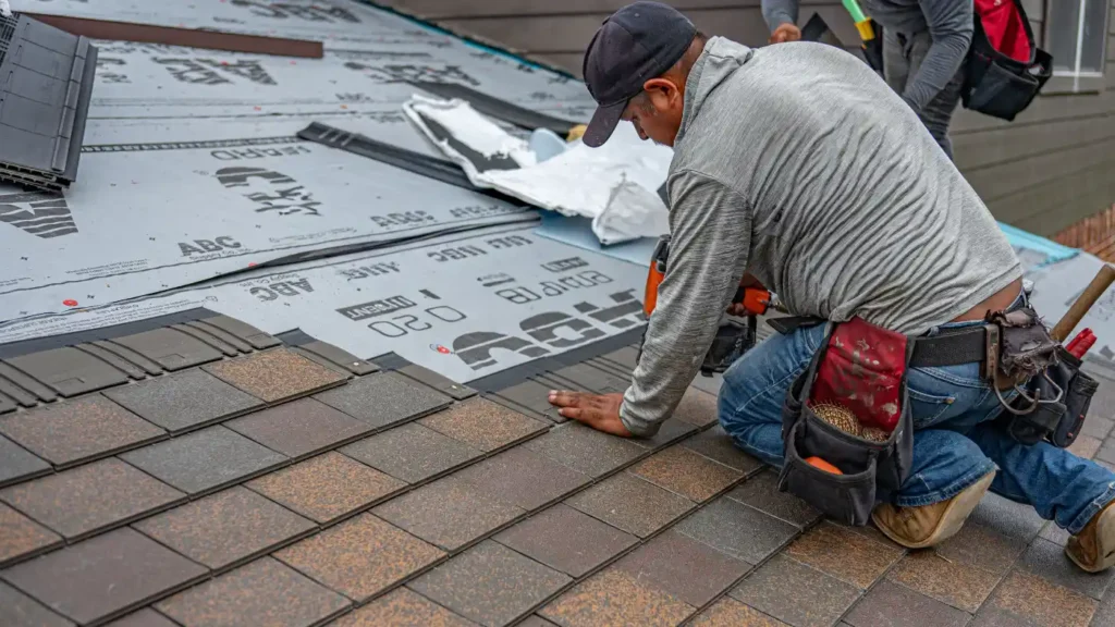 Pro roofer installing shingles and using the roofing nailer