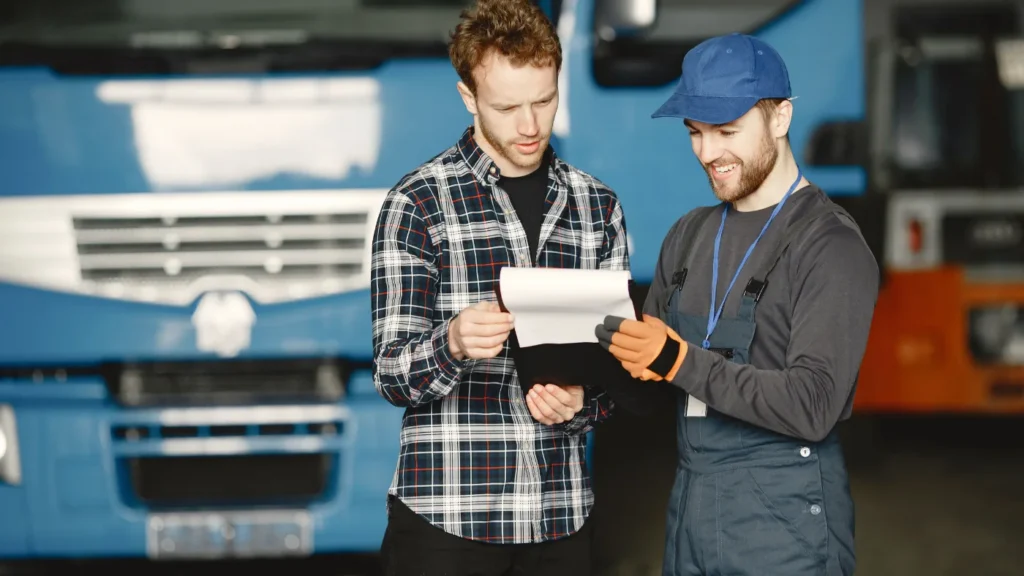 Two men in discussion over invoice documents