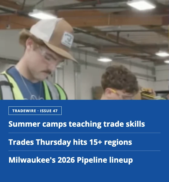 Young man in a workshop wearing a tan cap and high‑visibility vest, looking down; blue header overlay shows trade news headlines.