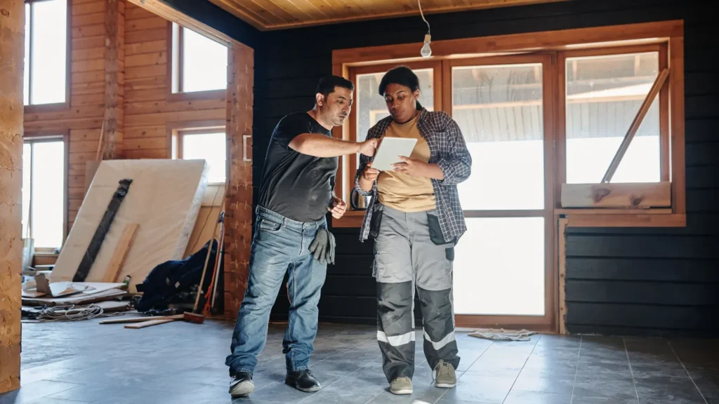 Commercial service contractors reviewing project details on a tablet at a job site.