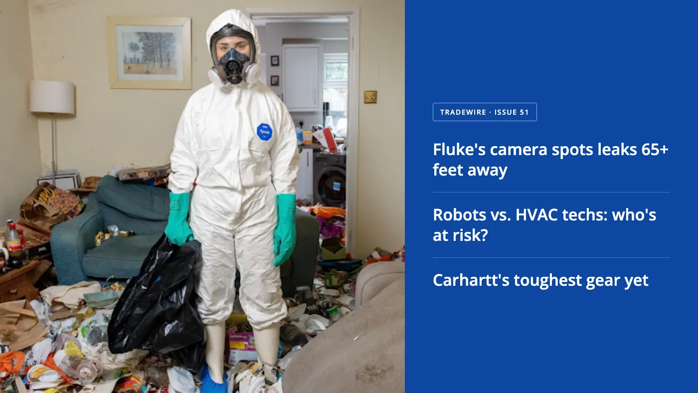 Person in a white hazmat suit and gas mask stands in a cluttered living room, holding a black trash bag and wearing teal gloves.